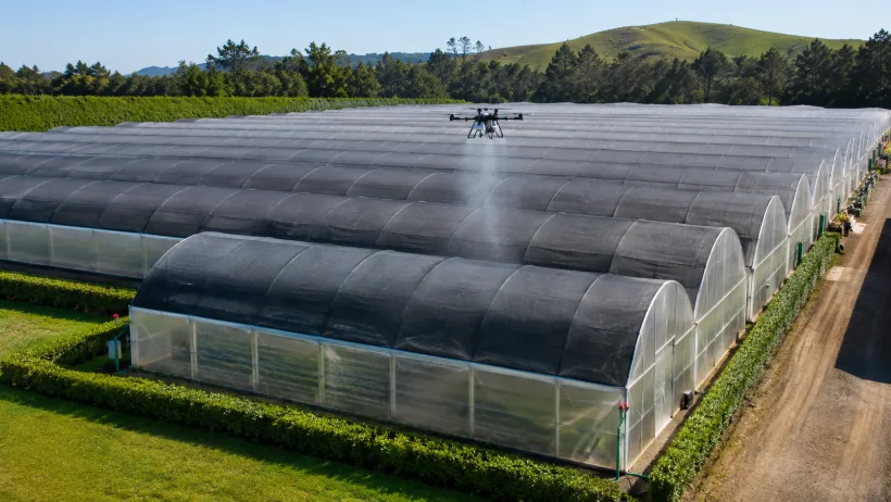 Drone-applied shade coating on a greenhouse