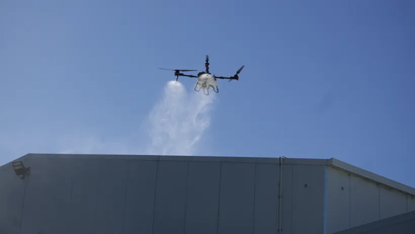 Drone-applied moss and mould treatment on a commercial roof